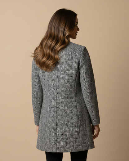 Woman wearing a gray coat against a beige background