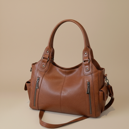 Brown leather handbag on a beige background