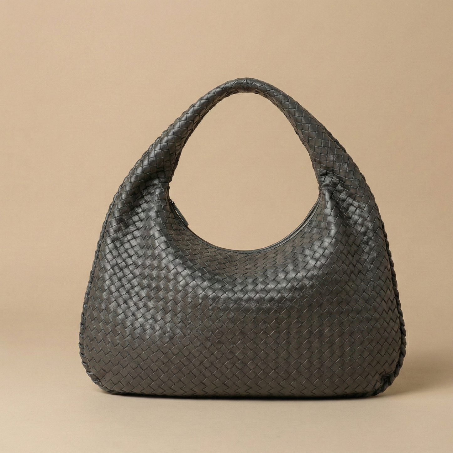Woven handbag on a beige background