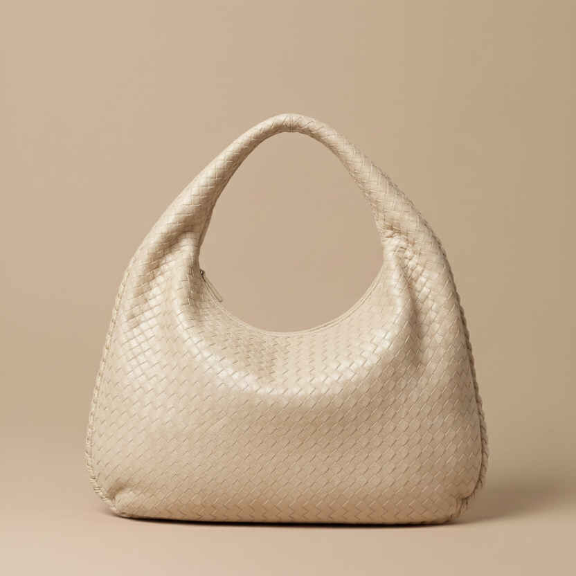 Beige woven handbag on a beige background