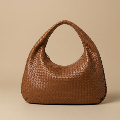 Brown woven handbag on a beige background